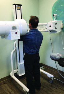 Figure 3. Patient standing in Digital Motion X-ray (DMX) machine, a diagnostic tool used to see the joints in motion and uncover instability often missed by static X-ray and MRI. 